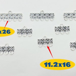 May include: Silver-toned metal jewelry connectors with a floral design. The connectors have multiple loops for attaching to other components. The image includes text that reads "11.2x26" and "11.2x16".