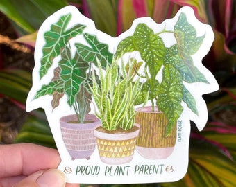 May include: A sticker featuring a hand-drawn illustration of three potted plants with the text "Proud Plant Parent" and "Plant Posse" in a whimsical font.