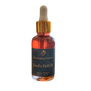 May include: A small, dark brown glass bottle with a gold lid and dropper. The bottle is labeled "The Healing Priestess Devil's Bell Oil Spiritual Oil Blend 30 ml/1 FL. OZ."