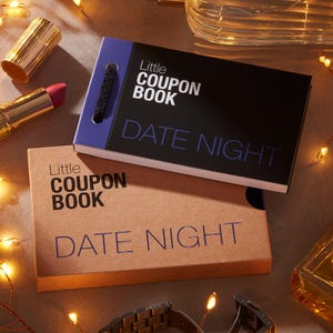 May include: Two small coupon books with the text "Little Coupon Book" and "Date Night". One book is black with a purple spine, the other is brown. A tube of lipstick and a watch are also visible.