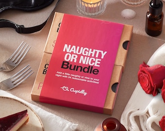 May include: A red and white box with the text "Naughty or Nice Bundle" and "Add a little naughty or nice to your night with 54 redeemable activities!"  The box is on a table with a white cloth, a red rose, and a glass candle.