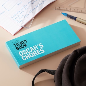 May include: A turquoise blue book with the title "Little Ticket Book Oscar's Chores" printed in black and white.