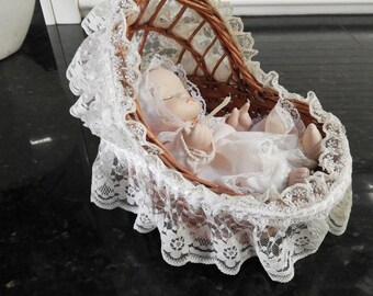 Vintage Porcelain Doll in Wicker Cradle With Lace