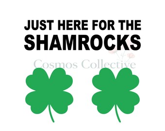 May include: A graphic design featuring the black text JUST HERE FOR THE SHAMROCKS at the top, with the faint gray text Cosmos Collective below it, and two bright green four-leaf clover illustrations positioned side by side at the bottom.