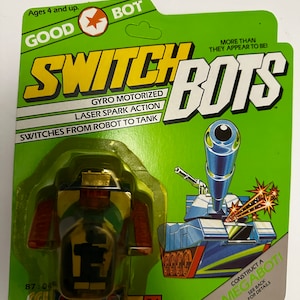 May include: A green, yellow and blue toy robot and tank transforming toy called Switch Bots. The toy is labelled "Gyro Motorized Laser Spark Action" and "Switches from Robot to Tank". The toy is labelled "Construct a Megaboti" and has a green background.