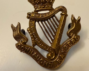 May include: A gold metal cap badge with a harp and crown, and the words "Connaught Rangers" inscribed on a scroll.