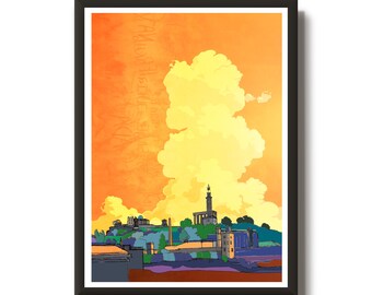 May include: A framed art print featuring a stylized cityscape under a vibrant orange and yellow sky. The artwork depicts buildings, a tower, and a large cloud formation. The print is in a black frame.