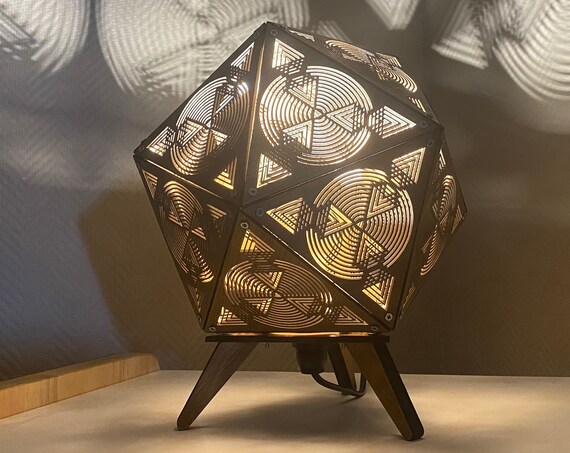 Wooden table lamp, bedside lamp platonic shape icosahedron, optical illusion drawing with shadow projection. Laser cutting.