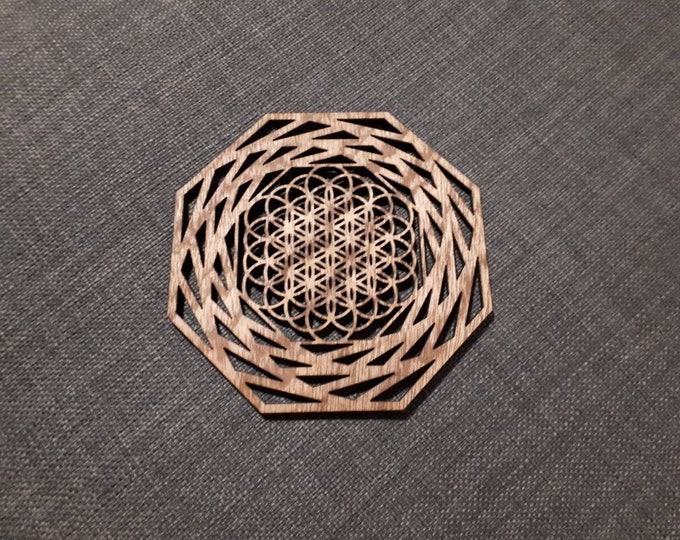 Wooden underglass pattern flower of life mandala. Sacred geometry, relaxation tea. Artisanal laser cutting.