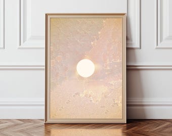 May include: Framed art print featuring a stylized sun against a textured, cloud-filled sky. The artwork has a warm color palette of peach, gold, and cream, with a light-colored sun in the center. The frame is a light gold color.