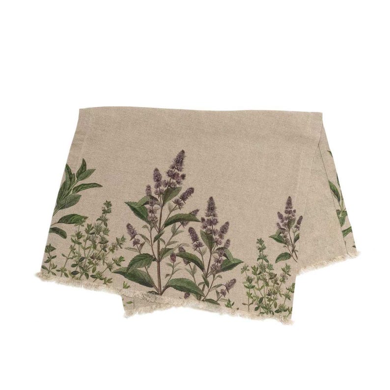 May include: A beige linen table runner with a frayed edge features a botanical print of green leaves and purple flowers.
