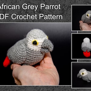 May include: Crocheted African Grey Parrot amigurumi toy. The parrot is grey with a white chest and red feet. The parrot is sitting in a hand.