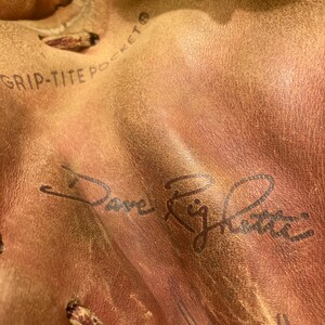 May include: Close-up of a brown leather baseball glove with the text "Grip-Tite Pocket" and a signature that reads "Dave Righetti".