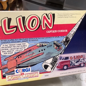 May include: A vintage Corgi Comic Classics diecast model set featuring a red and white VW van and a comic illustration of a futuristic aircraft. The box reads "LION Captain Condor" with text from the comic.
