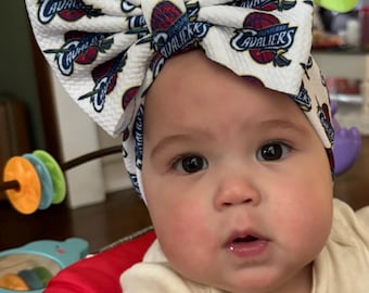 Custom made big bows and head wraps in your favorite team!