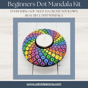 May include: A Beginners Dot Mandala Kit. The image shows a hand-painted dot mandala candle holder with a tealight candle. The design features a rainbow of colours, including red, orange, yellow, green, blue, and purple. The text on the image says "EVERYTHING YOU NEED TO CREATE YOUR OWN BEAUTIFUL DOT MANDALA."