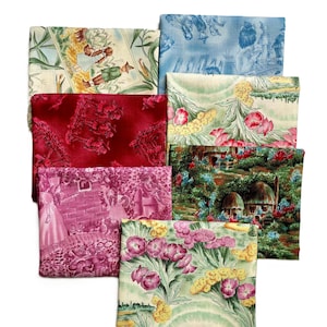May include: A collection of folded fabric squares featuring various vintage-style patterns. The fabrics display scenes with figures, floral designs, and landscapes in shades of red, pink, blue, and green. The fabrics are arranged on a white background.