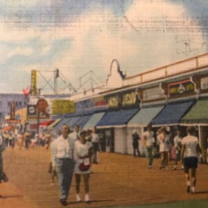 May include: A vintage postcard depicting a bustling boardwalk scene with shops and people walking along the sidewalk. The shops have colorful awnings and signs, including "Gift Shop" and "Sea Isle".
