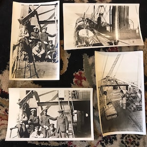 May include: Four black and white photographs of a group of men in uniform standing on a ship's deck. The men are all wearing hats and some are holding tools. The photos are taken from different angles and show the men in various poses.