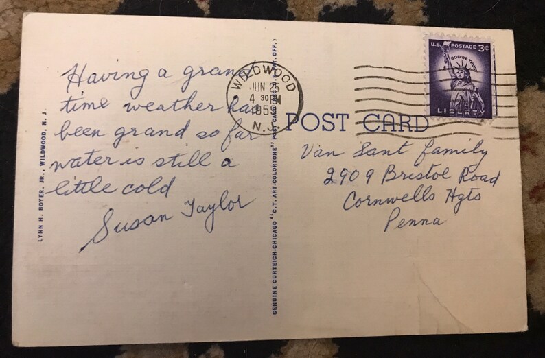 May include: A vintage postcard with a handwritten message that reads "Having a grand time weather has been grand so far water is still a little cold Susan Taylor". The postcard is addressed to Van Sant Family, 2909 Bristol Road, Cornwells Hgts, Penna. A 3&cent; US postage stamp with a picture of the Statue of Liberty is in the upper right corner.