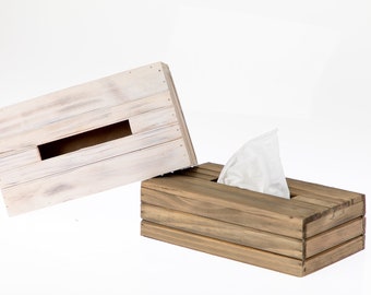 May include: A wooden tissue box holder with a whitewashed lid and a natural wood base. The lid is open and a white tissue is visible inside.