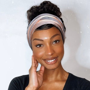 woman smiling while wearing a peach mocha scarf