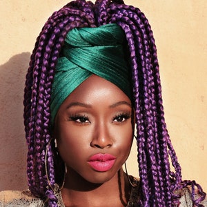 woman wearing a green velvet head wrap with purple braids