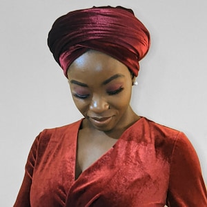 woman wearing red colored velvet scarf while smiling