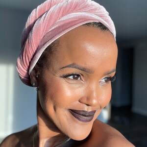 woman smiling wearing pink velvet scarf