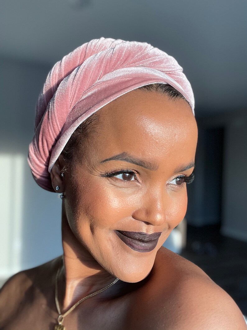 woman smiling wearing pink velvet scarf