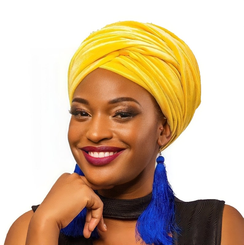 Yellow turban pop of color on woman wearing blue earrings