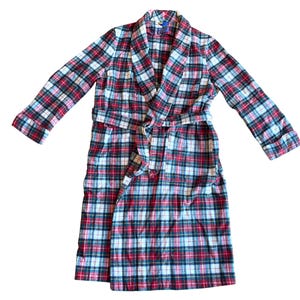 May include: A plaid robe in red, white, and green. The robe has a shawl collar, long sleeves, and a matching belt. The fabric appears to be soft and comfortable, suitable for lounging. The robe is a classic style.