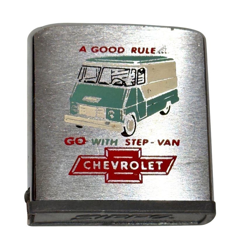 May include: A silver-toned Zippo lighter with a graphic of a green and beige step-van. The text reads "A GOOD RULE" and "GO WITH STEP-VAN" above a red Chevrolet logo.