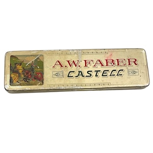 May include: Vintage A.W. Faber Castell pencil case. The rectangular tin case has a gold finish with the brand name in red and black. A small illustration of knights on horseback is on the left side of the case.