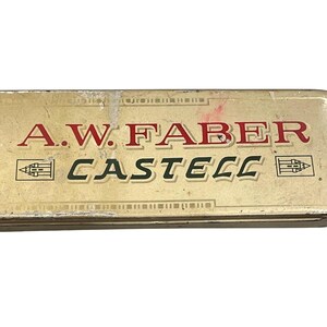 May include: A.W. Faber Castell pencil case. The rectangular case is a light tan colour with the brand name in red and black lettering. The case has a vintage appearance.