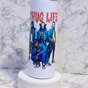 May include: White stainless steel tumbler with a graphic of four horror movie characters wearing blue jackets and the text "THUG LIFE" in red letters.
