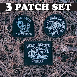 May include: Set of three black embroidered iron-on patches with white text and designs. The patches feature the text "Dead Inside but still Caffeinated", "Sleep When You're Dead", and "Death Before Decaf".