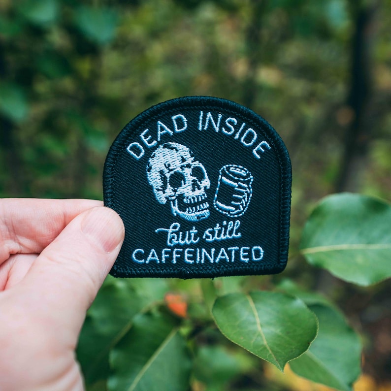 May include: Black embroidered patch with a skull and a can, and the text "Dead Inside but still Caffeinated".