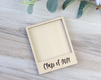 May include: A wooden photo frame with a blank space for a picture and the text "Class of 2021" engraved on the bottom.