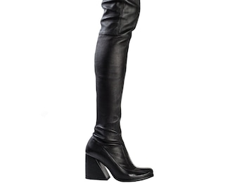 Könnte beinhalten: Schwarze Overknee-Stiefel aus Leder mit einem dicken Absatz und einem Reißverschluss an der Seite.