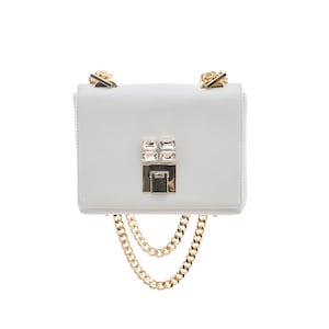 May include: A white leather crossbody bag with a gold chain strap and a crystal embellished clasp.