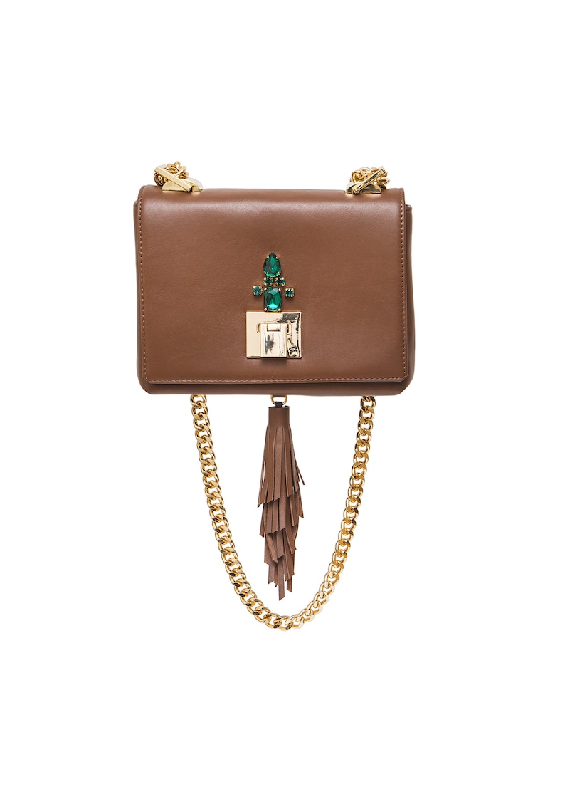 May include: A brown leather crossbody bag with a gold chain strap and a green gem embellishment on the front flap. The bag has a brown tassel hanging from the bottom.