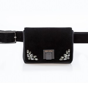 May include: Black suede fanny pack with a silver buckle and crystal embellishments. The bag has the text "ANNA KRIS" on the front.