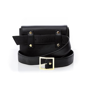 May include: Black leather belt bag with a gold buckle and a detachable strap. The bag has a flap closure and a small pocket on the back.