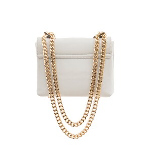 May include: A white leather shoulder bag with a gold chain strap. The bag has a flap closure and a small, rectangular shape.