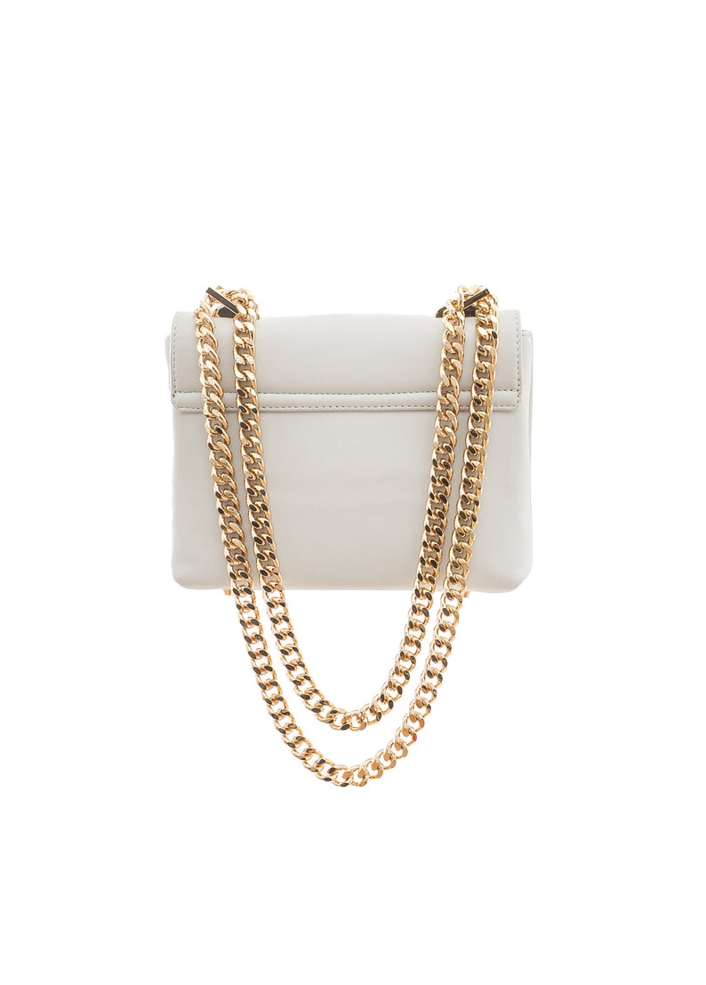 May include: A white leather shoulder bag with a gold chain strap. The bag has a flap closure and a small, rectangular shape.