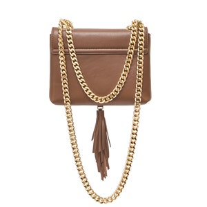 May include: A brown leather crossbody bag with a gold chain strap and a brown tassel.