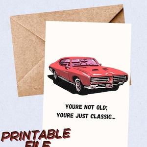 May include: A printable greeting card with a red classic car illustration. The card reads "YOU'RE NOT OLD; YOU'RE JUST CLASSIC..." and "PRINTABLE FILE" in brown. A brown envelope is also visible in the image.
