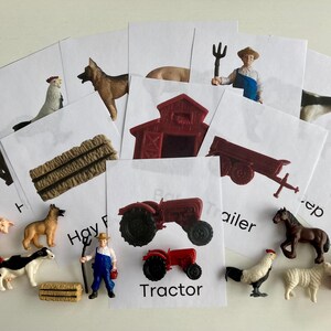 May include: A collection of farm-themed flashcards and miniature toy figures. The cards feature illustrations of farm animals and objects, such as a tractor, trailer, and hay bale. Toy figures of a pig, cow, horse, and farmer are also present.
