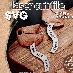 May include: Two brown wooden fortune cookie shapes with white text that reads "You Got This". The fortune cookies are on a wooden surface. The image is labelled "laser cut file SVG DIGITAL DOWNLOAD".
